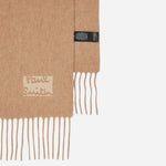 Close up of the edges on the Men's Tan Cashmere Scarf with Signature Logo Patch.