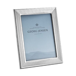 This Bernadotte Small Picture Frame 4x6" by Georg Jensen has a mirrored stainless steel frame with a ridged edge.