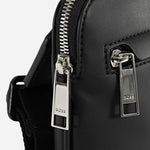 Side view of the Ray MS Black Faux Leather Zip Top Envelope Bag with Pattern Detail.