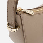 Side view of the Beyond Halfmoon Beige Leather Cross Body Bag.