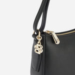 Side view of the Black Leather Numah Minibag with Double 'B' Monogram Charm.