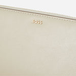 Close up of the BOSS logo on the Numah Beige Leather 12CC Zip Around Purse.