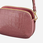 Side view of the Dukes Place French Rose Faux Croc Medium Zip Top Cross Body Bag.