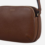 Side view of the Dukes Place Textured Chocolate Brown Medium Zip Top Cross Body Bag.