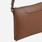 Side view of the Pockets Saddle Brown Small Zip Top Cross Body Bag.