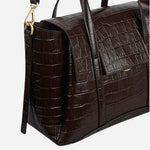 Side view of The Chancery Dark Oak Faux Croc Medium Flapover Multiway Bag.