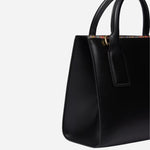 Side view of the Paul Smith Women's Black Leather Top Handle Bag with 'Signature Stripe' Trims.