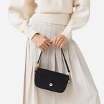 The removable grab handle on the Bathurst Mews Black Small Flapover Cross Body Bag.