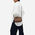 The adjustable cross body strap on the Dukes Place Textured Chocolate Brown Medium Zip Top Cross Body Bag.