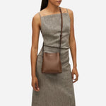 The adjustable cross body strap on the Dukes Place Textured Chocolate Brown Small Compartment Cross Body Bag.