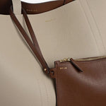 The zipped leather pouch of the Hanbury Row Chocolate Brown Large Reversible Open Top Tote Bag.