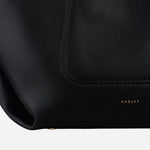 Corner view of The Compton Black Medium Zip Top Shoulder Bag.