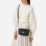 The adjustable and removable cross body strap on the Dukes Place Texture Chocolate Brown Small Compartment Cross Body Bag.