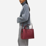 Adjustable and detachable cross body strap on the Dukes Place Carmine Red Leather Medium Zip Top Multiway Bag.