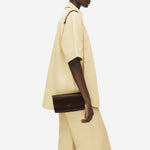 The The Rathbone Faux Croc Dark Oak Micro Flapover Cross Body Bag with cross body strap.