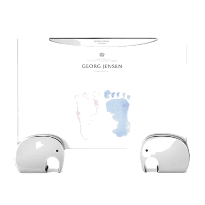 This Georg Jensen Elephant Picture Frame 4x6 IN has two elephants holding the clear frame.
