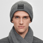 This BOSS Grey Metaverse Knit Beanie Hat and Scarf Set comes in a branded gift box with a clear top, presenting the hat and scarf neatly.