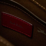 The Paul Smith signature embossed in silver foil on a patch inside the Paul Smith Khaki 'Floral Street' Organic Cotton Blend Canvas Musette Bag.