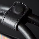 The handle keeper on the Paul Smith Women's Black Leather Top Handle Bag with 'Signature Stripe' Trims.