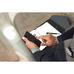 Model using a phone after writing in the Montblanc Augmented Paper set.