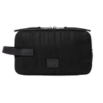 This Black Shadow Stripe Wash Bag by Paul Smith has a striped exterior with a black metal plaque on the front with the signature name.