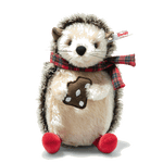 This Steiff Ivo the Christmas Hedgehog, 19 cm is seen eating a gingerbread biscuit with a scarf wrapped around his neck.
