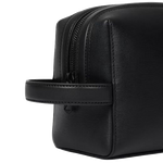 The tonal leather handle on one side of the Straw-Grain Black Leather Wash Bag.