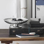 This Georg Jensen Stainless Steel Bernadotte Dish on Stand can hold personal items.