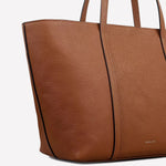 The Radley brand name has been embossed onto the bottom front of this tote bag.