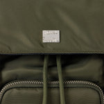 Close-up of Paul Smith green backpack with a brand label on green nylon.