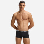 Front view of the BOSS 3-Pack of Black Cotton Blend Motion Boxer Shorts with Three Stripe and Logo Waistband.