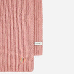 Edge of the Women's Pink Lambswool Scarf with Swirl Heart Logo.