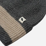 Contrasting stripe and Scottie dog mascot tag on the Knitters Lane Dark Grey Hat with Contrasting Stripe.