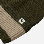 Contrasting stripe and Scottie dog mascot tag on the Knitters Lane Pine Needle Hat with Contrasting Stripe.