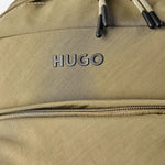Close up of the HUGO logo on the front of the BOSS Ayden Army Green Backpack with Hugo Raised Logo.