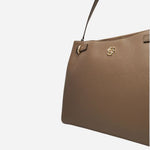 The double ‘B’ monogram on the front of the Beyond Beige Grained Leather Tote Bag with Double 'B' Monogram.