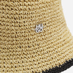 Close up of the BOSS Calantha RA Beige and Black Woven Bucket Hat with Metal Logo.