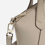 Close up of the BOSS Lenah Beige Zip Tote Bag with Metal Logo.