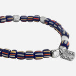 The Paul Smith signature on the Paul Smith Navy Blue Glass Bead Bracelet with Signature Stripe Pinstripe.