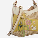 Side view of the Radley Spring Blooms Raffia and Leather Small Open Top Cross Body Bag.