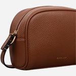 Side view of the Radley The Daily Cognac Leather Small Zip Around Cross Body Bag.