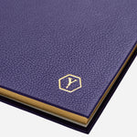 The Yard-O-Led logo embossed in gold foil on the front of the Yard-O-Led Sampson A5 Luxury Purple Leather Notebook.
