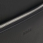 The embossed BOSS logo on the front of the BOSS New Crosstown NS Reporter Bag in Natural-Grain Black Leather with Zip.