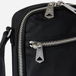 Close up of the Paul Smith Black Recycled Polyester Small Flight Bag with Signature Stripe Zebra Logo.