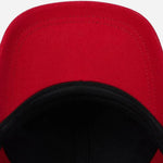 Underneath the peak of the Paul Smith Red Seasonal Cotton Cap with Signature Stripe Zebra Logo.