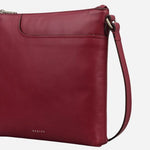 Side view of the Pockets Carmine Red Leather Small Zip Top NS Cross Body Bag.