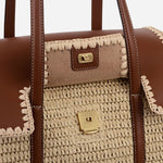 The snap closure on the Radley The Chancery Natural Woven Raffia Medium Flapover Shoulder Bag.