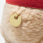 The Steiff Limited Edition 100th Anniversary 20 cm Disney Winnie the Pooh plays a "Winnie the Pooh" melody.