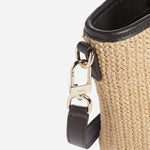 Close up of the BOSS Jala Woven Cross Body Bag with Metal Logo.