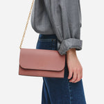 The Radley Lynton Road Carnation Leather Wallet On a Chain with chain strap attached.